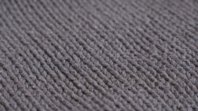 Thick wool ribbing or stockinette stitch knitting work slow tilt 4K 2160p 30fps UltraHD footage - Close-up of man brown sweater details and knitwork 3840X2160 UHD tilting video