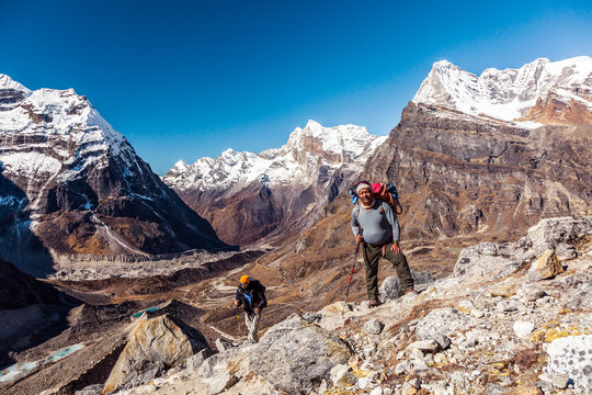 Sherpa Mountain Guide And His Client On Mountain Footpath