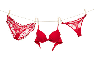 Female red underwear hanging on rope