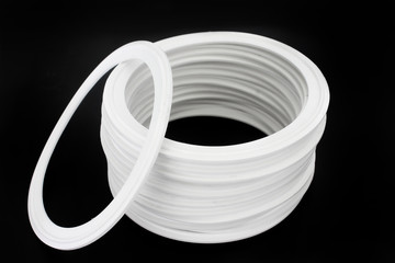 Rubber white silicone sealing spare parts for industryon black background.