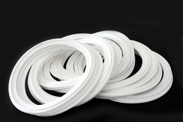 Rubber white silicone sealing spare parts for industryon black background.