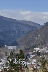 Residential district of bulgarian houses in winter village Pasarel with Hydro-Electric power station, Bulgaria 