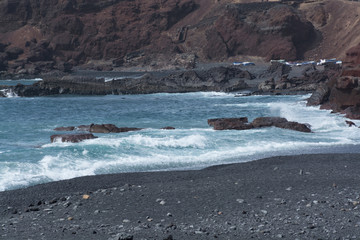 Obraz premium Wild sea and volcanic lava rocks west coast of Lanzarote island,