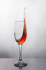 splash of red wine in a glass