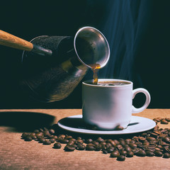 Hot coffee. Coffee grinder, turk and cup of coffee