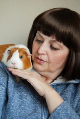 woman holding a Guinea pig