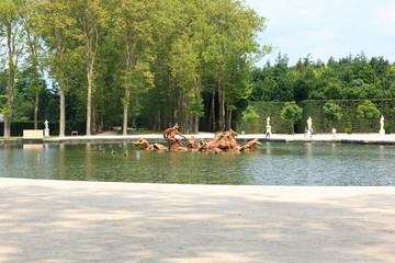 The huge park surrounding the Palace of Versailles with beautiful fountains, flowers and...