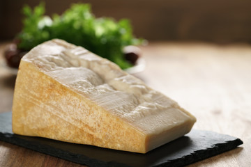 big chunk of italian parmesan cheese on slate board, simple rustic photo