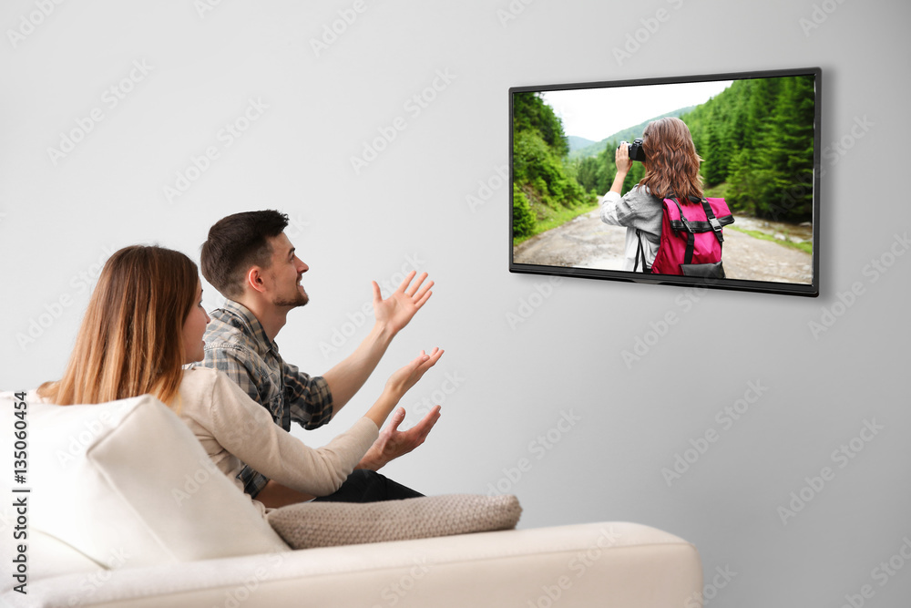 Canvas Prints family watching television at home. leisure and entertainment concept.