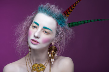 Creative portrait of young woman with artistic make-up.