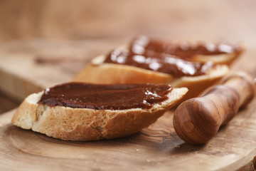 baguette slices with homemade hazelnut cream gianduja on cutting board