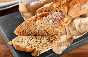 Sliced rye bread on wooden cutting board closeup
