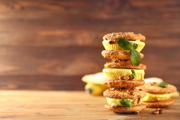 Delicious lemon ice cream cookie sandwiches on wooden background