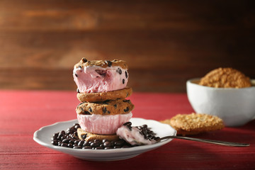 Delicious cookies with ice cream and chocolate chips on plate