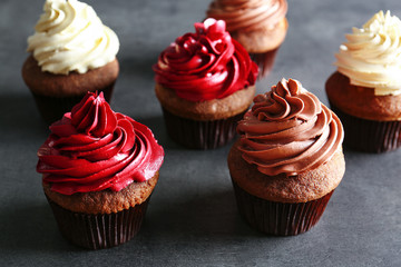 Tasty chocolate cupcakes on grey textured surface