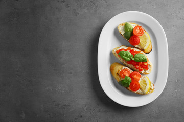 Delicious toast with tomatoes on plate