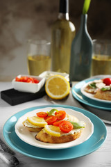 Plate with delicious bruschetta on table