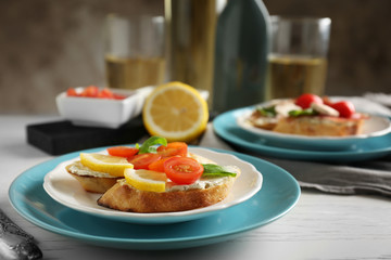 Plate with delicious bruschetta on table