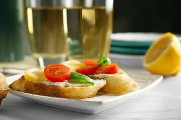 Plate with delicious bruschetta on table