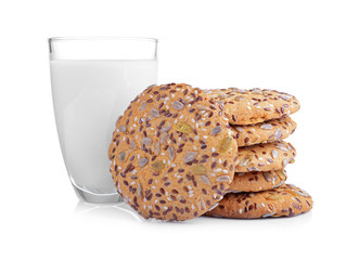 Delicious cereal cookies with glass of milk on white background