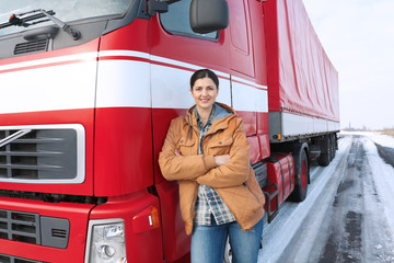 Female driver near big modern truck outdoors