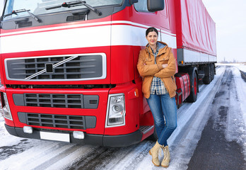 Female driver near big modern truck outdoors