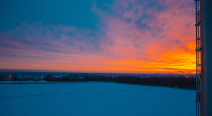 Naklejka premium Sunrise city field with spring wheat