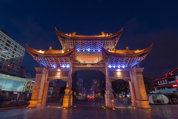 The gate of Yunnan Nationalities Village and many people are vis