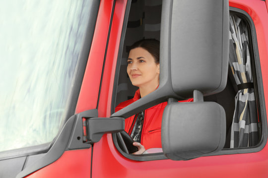 Young woman driving big modern truck