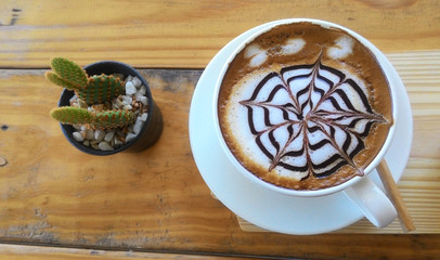 cup of cappuccino on the wooden table background