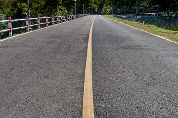 Obraz premium Asphalt road with yellow line