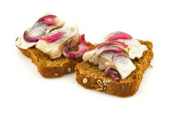 Sandwich with herring, tasty bread and red onion isolated on white background