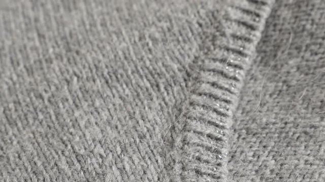 Close-up of modern hairy women sweater knitting texture 4K 2160p 30fps UltraHD footage - Shallow DOF fashion gray knitwork 3840X2160 UHD tilting video 