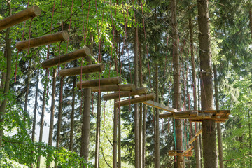Fototapeta na wymiar Climbing park, adventure playground in the forest