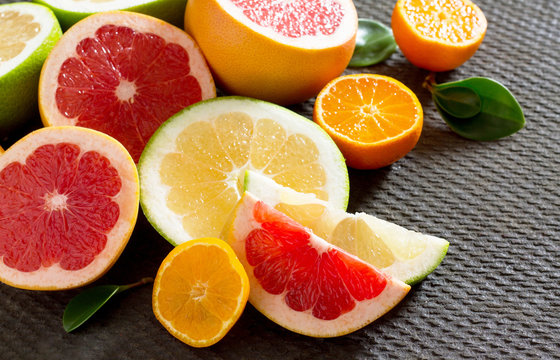 Citrus fruit collection of sliced grapefruits and tangerines on