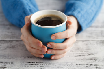 big mug of coffee in hands