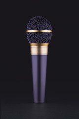 A violet wireless microphone on a black background