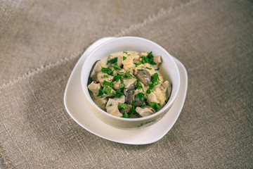 mushrooms of a veshanka and champignons in sauce with macaroni in a white plate on a table