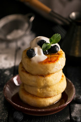 Sweet cheese pancakes on a plate with berries