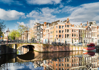 Old houses facades over canal with mirror reflections, Amstardam, Netherlands