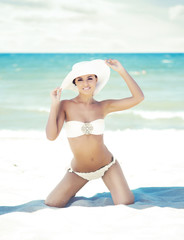 Young woman in a sexy swimsuit on the beach