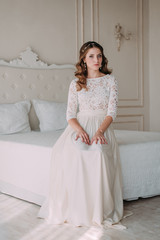 Fototapeta premium fashion studio photo of beautiful elegant bride with dark hair in luxurious wedding dress with headband