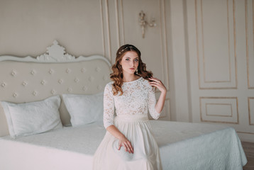 fashion studio photo of beautiful elegant bride with dark hair in luxurious wedding dress with headband