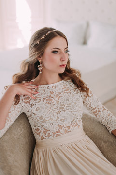fashion studio photo of beautiful elegant bride with dark hair in luxurious wedding dress