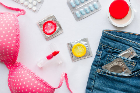 clothing and contraceptives on a white background