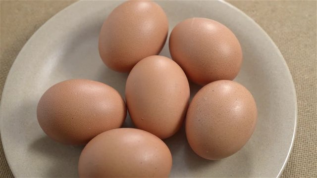 Half a dozen brown eggs rotating. Seamless looping
