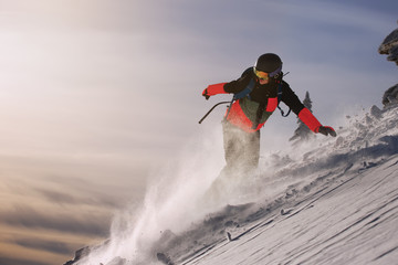 Fototapeta na wymiar Fast snowboarder downhill in powder.