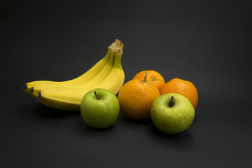 Healthy fruits on black background.