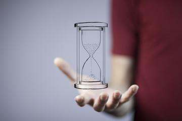 businessman holding sandglass in hand