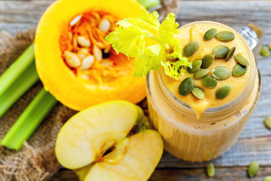 Pumpkin smoothie with apple and celery closeup.